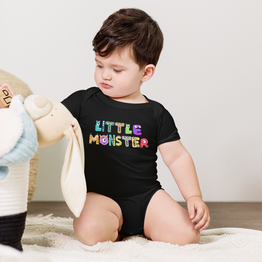 Black Little Monster baby bodysuit with playful cartoon monster letters spelling “little monster,” printed on a Bella + Canvas 100B one-piece. Made from 100% soft ring-spun cotton, this baby Halloween bodysuit is available in sizes newborn to 24 months and comes in black or white. Features an envelope neckline, snap closure, and side-seamed durability. Perfect for baby’s first Halloween, fall outfits, or as a fun baby shower gift.