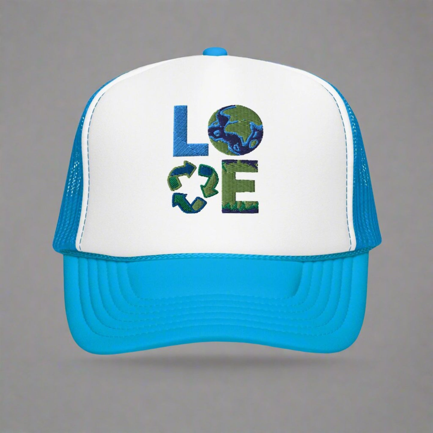 LOVE Earth Day Foam Embroidery Trucker Hat, which features the letters L-O-V-E in large embroidered block letters in shades of blue and green. The hat is teal and white. The letters each represent water, earth, recycling and nature. by jaecrece.com
