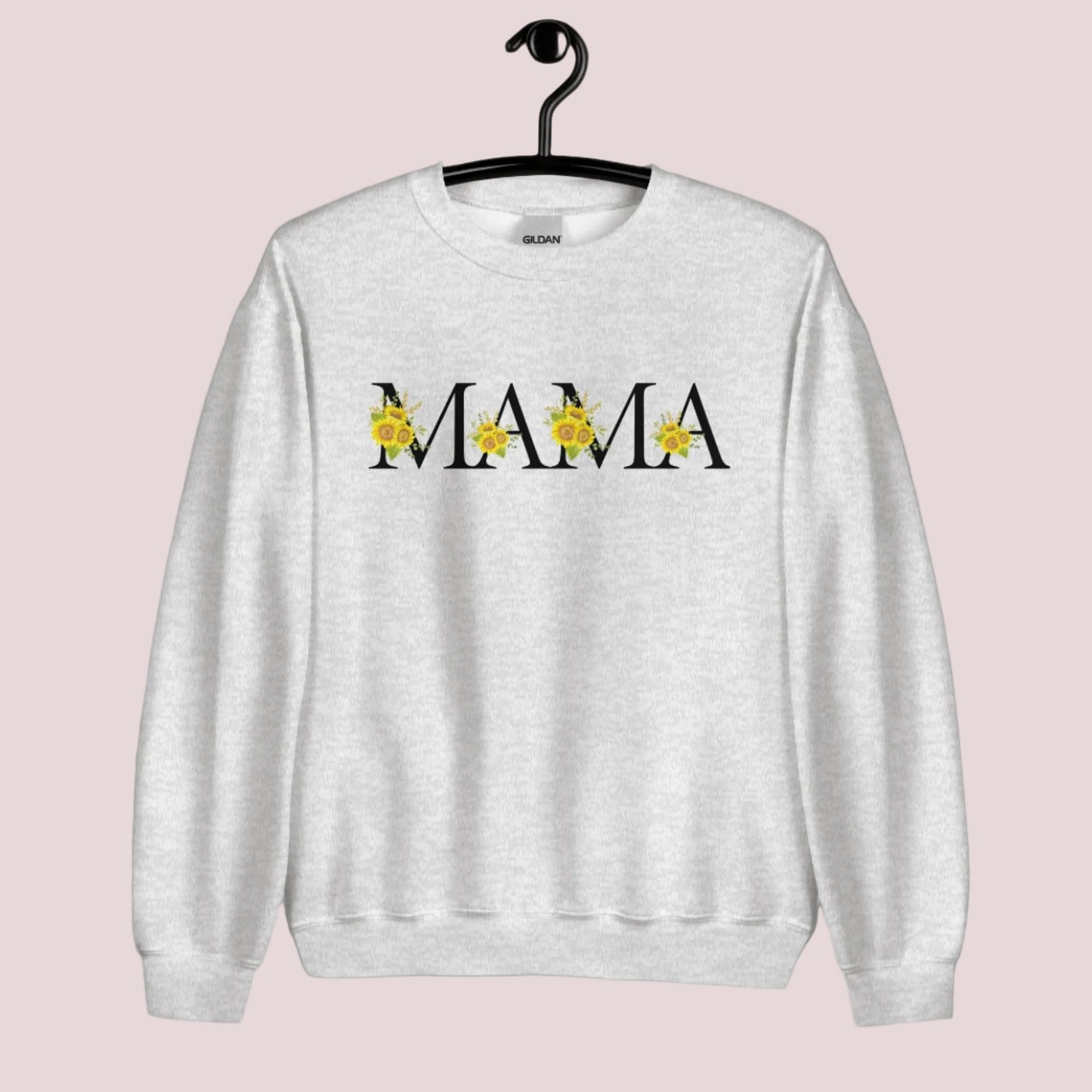 Image: MAMA sunflower crewneck sweatshirt, available in white, light pink and ash. This pullover crewneck features the word MAMA in large black block letters with sunflower calligraph accent. A great baby announcement gift or Mothers day present by jaecrece