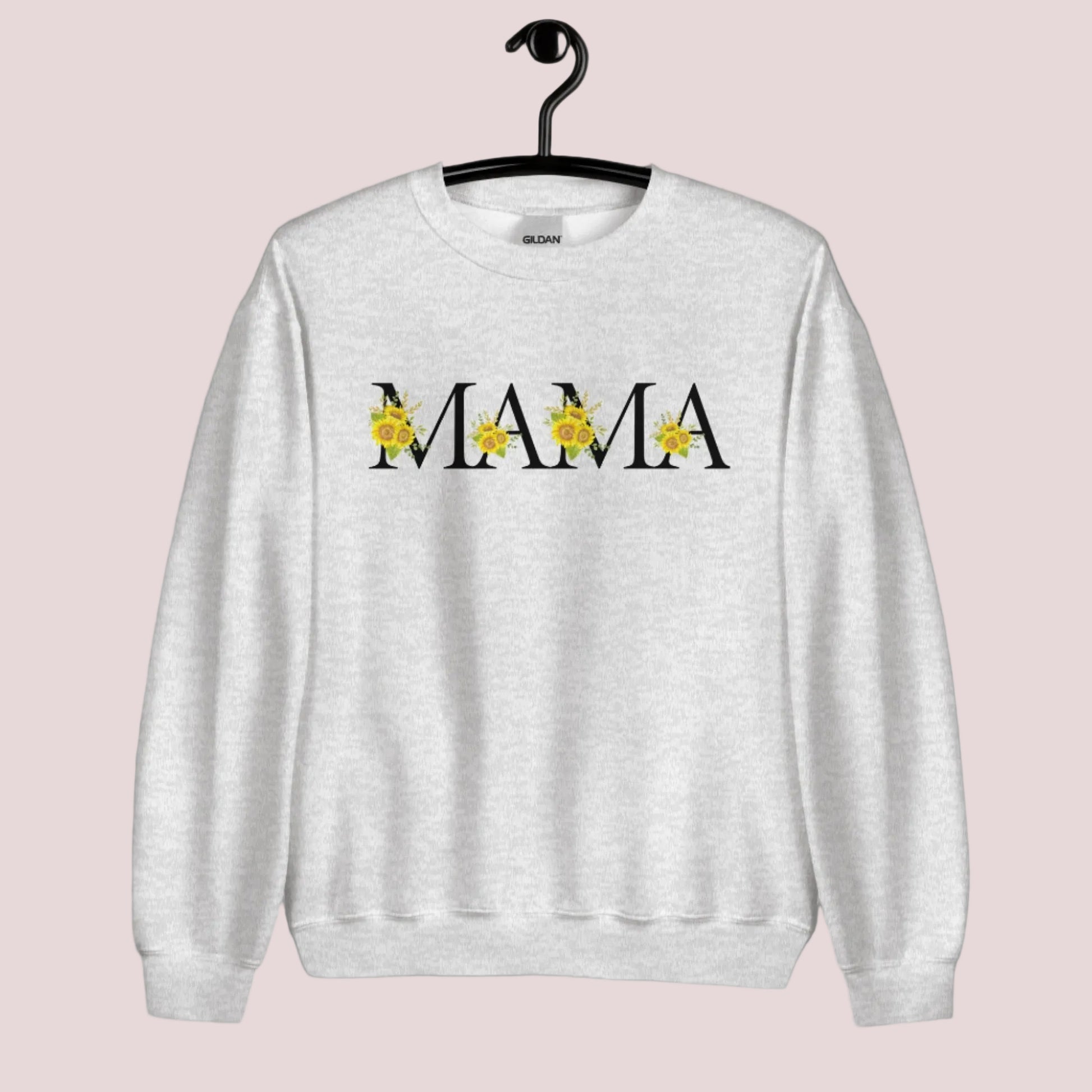 Image: MAMA sunflower crewneck sweatshirt, available in white, light pink and ash. This pullover crewneck features the word MAMA in large black block letters with sunflower calligraph accent. A great baby announcement gift or Mothers day present by jaecrece