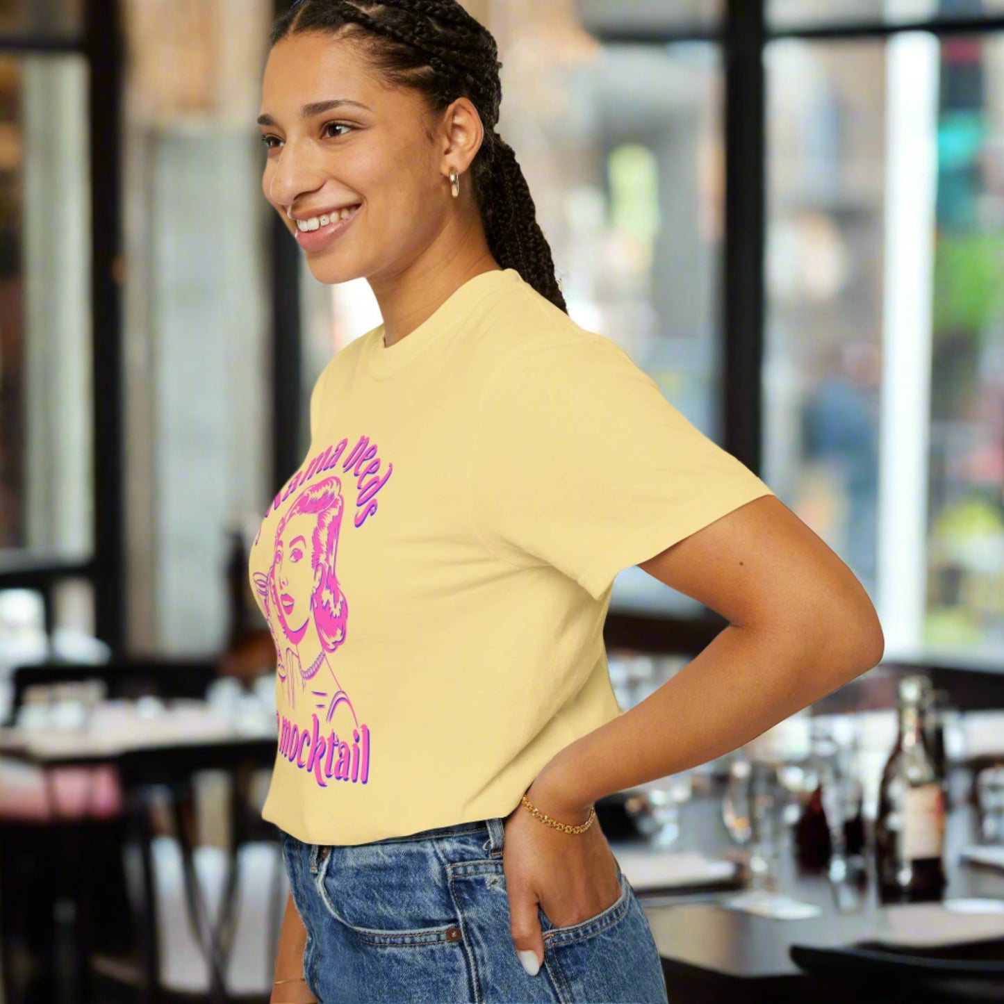 Image: A playful and stylish Mama Needs a Mocktail t-shirt featuring a bright pink neon graphic of a pop art vintage mom enjoying a drink. This Comfort Colors tee, available in six color options, is a fantastic way to celebrate pregnancy, sobriety, or the choice to go alcohol free. Whether worn at a baby shower or a mocktail happy hour, this shirt brings humor and positivity to any setting, by jaecrece.