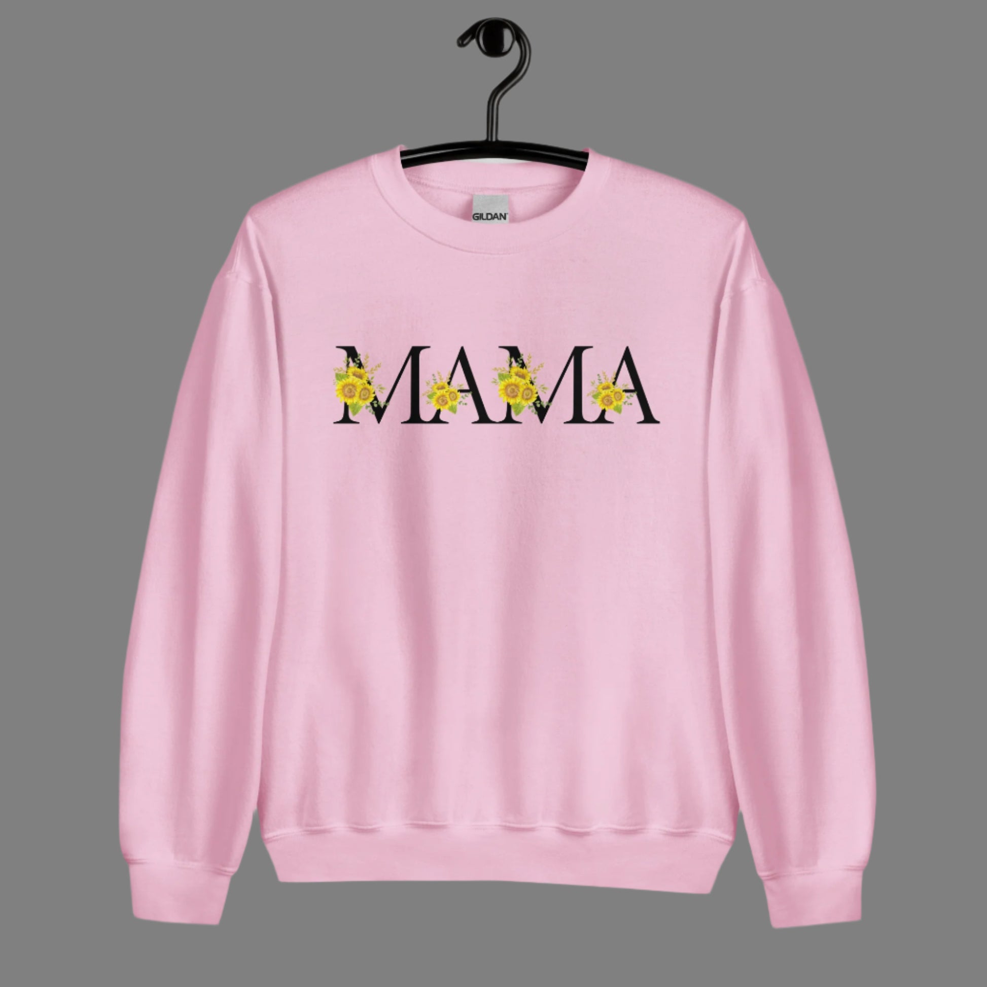 Image: MAMA sunflower sweatshirt , available in white, light pink and sand. This pullover crewneck features the word MAMA in large black block letters with sunflower calligraph accent. A great baby announcement gift or Mothers day present by jaecrece