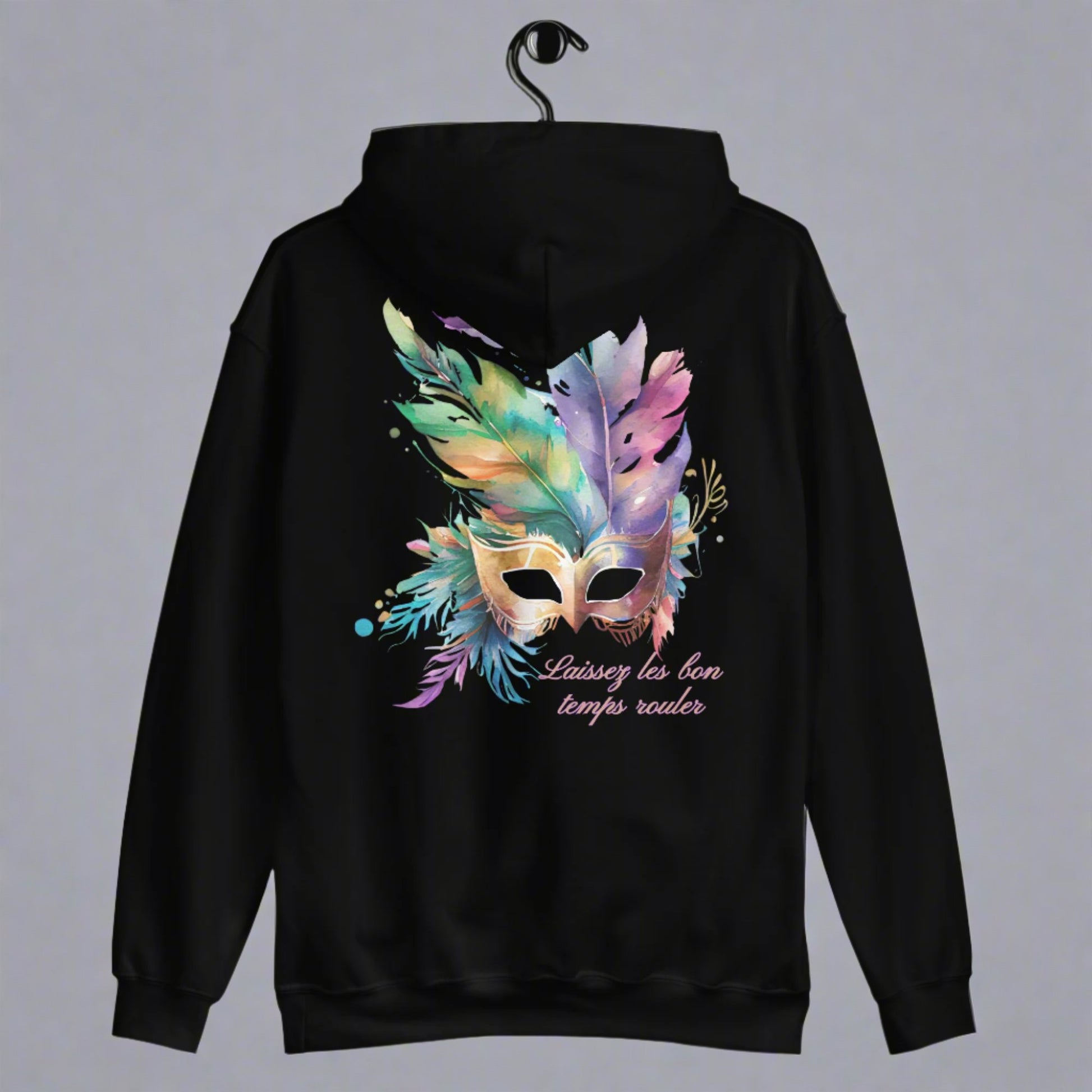 Image: Black Adult Mardi Gras Hoodie, printed on front and back. The front of the sweatshirt has a watercolor carnival mask, and the back features an oversized graphic of the same party mask with the text Laissez les on temps rouler, by jaecrece