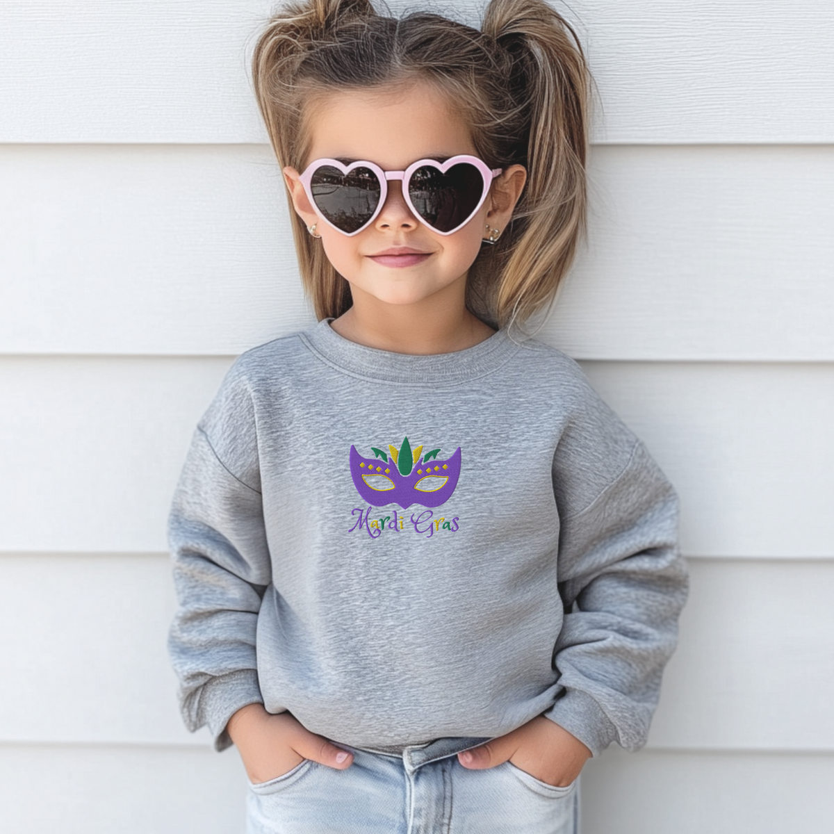 Get parade-ready with this youth Mardi Gras sweatshirt featuring a detailed embroidered mask in classic purple, green, and gold and bold “Mardi Gras” lettering. Available in kids sizes XS–XL, this holiday sweatshirt is soft, comfortable, and festive for school parties, family photos, or Mardi Gras parades. Part of a matching family Mardi Gras outfit collection, it’s perfect for festive kidswear and carnival-inspired fashion.