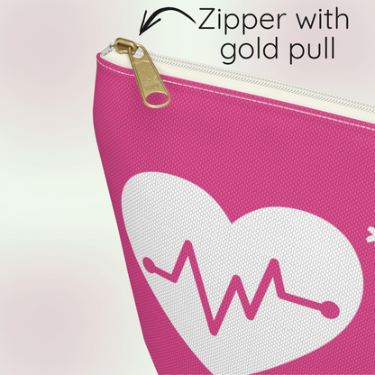 Close up of a pink medical alert zip pouch with a white heart graphic and pink heartbeat line, showing a gold zipper pull with text reading 'Zipper with gold pull'.