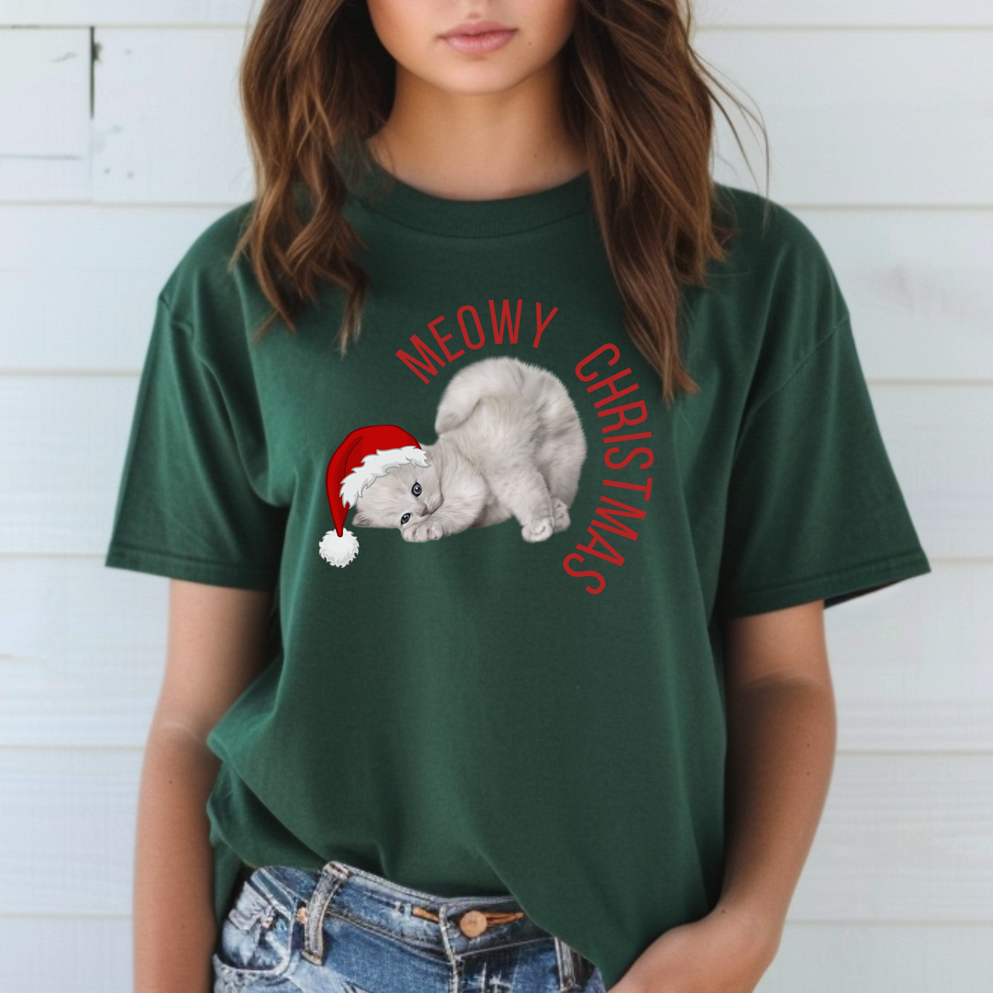 Add a touch of humor to your holiday wardrobe with this Meowy Christmas adult unisex tee featuring a large print of a festive grey kitten in a Santa hat. Designed for cat fans and lovers of Christmas puns, this shirt is available in sizes XS–5XL and is part of a matching family collection with coordinating kids’ options and a festive blanket. A cozy, funny pick for family photos or cat-themed holiday gifts.