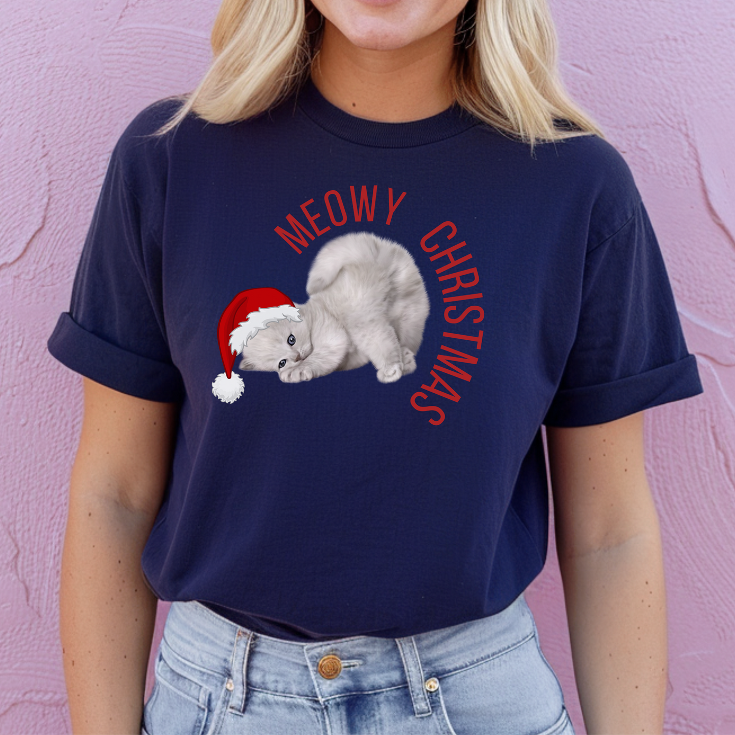 Make spirits bright with this Meowy Christmas adult t-shirt showcasing a Santa-hat-wearing grey kitten and cheerful “Meowy Christmas” text. This unisex shirt comes in sizes XS–5XL and is part of a full family matching collection, including toddler and youth sizes, sweatshirts, and blankets. It’s soft, funny, and ideal for holiday parties, gifting cat lovers, or coordinating Christmas morning looks.