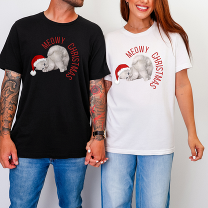 Image: A man and a woman wearing a black and white Meowy Christmas family matching tshirt. These unisex tees feature a grey kitten wearing a red Santa hat. These shirts are also available in child sizes for family matching holiday outfits. 