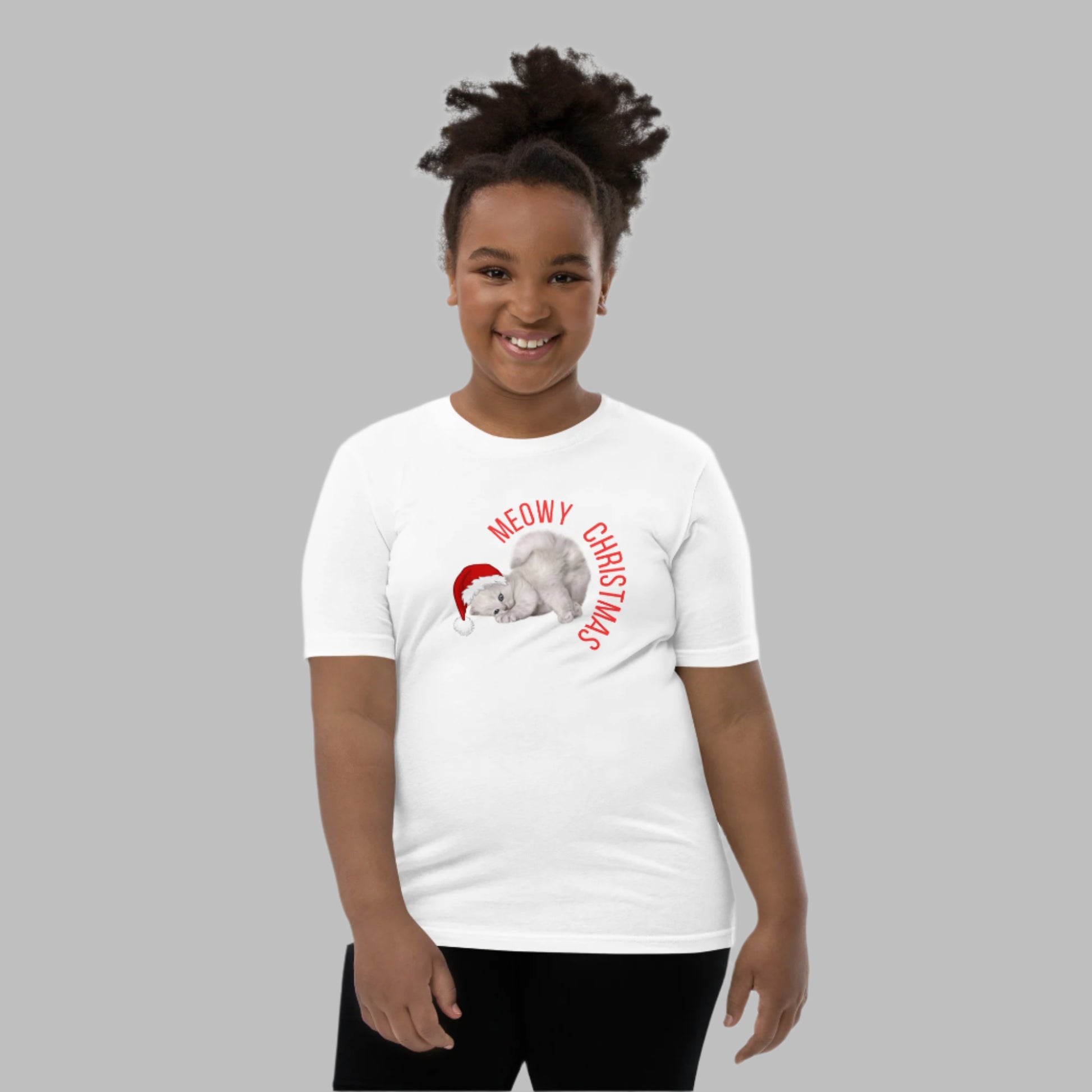 Celebrate the season with this Meowy Christmas youth unisex shirt! Featuring an adorable gray kitten with blue eyes and a Santa hat, this holiday t-shirt is perfect for Christmas-loving kids. Ideal for family matching holiday outfits, festive school days, or cozy Christmas Eve fun. Comes in sizes S–XL for boys and girls. A funny cat-themed tee that makes a great Christmas gift for cat lovers and kids alike.