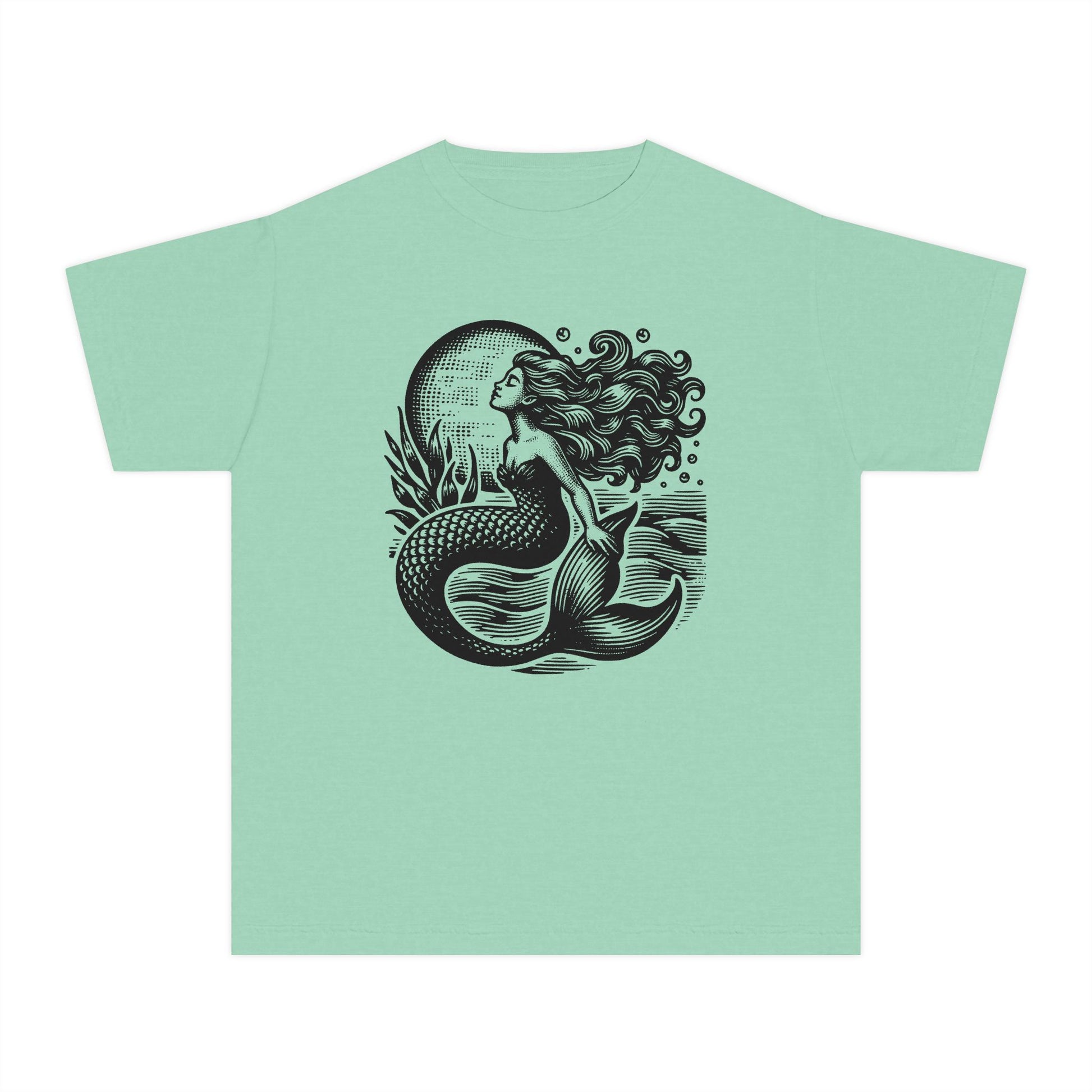Mermaid aesthetic girls shirt with a linocut inspired ocean art design featuring a mystical mermaid beneath a glowing moon and textured sea waves. Soft Comfort Colors youth tee with a vintage garment dyed finish and relaxed classic fit for comfortable all day wear. Perfect for coastal aesthetic wardrobes beach vacations summer adventures matching mommy and me outfits and nautical inspired fashion. Great gift idea for girls who love ocean themes seaside style and whimsical graphic tees.