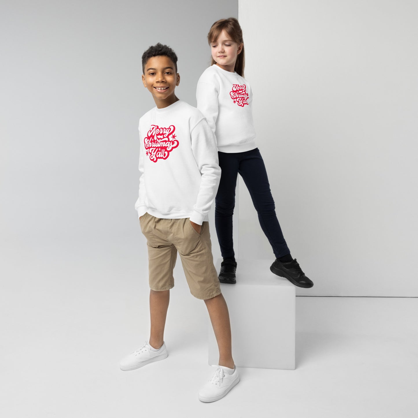 A cheerful red “Merry Christmas Y’all” graphic pops on this classic kids sweatshirt, combining festive vibes with comfort. Ideal for matching family outfits and seasonal events, this Gildan youth pullover is a must-have for your child's Christmas wardrobe.
