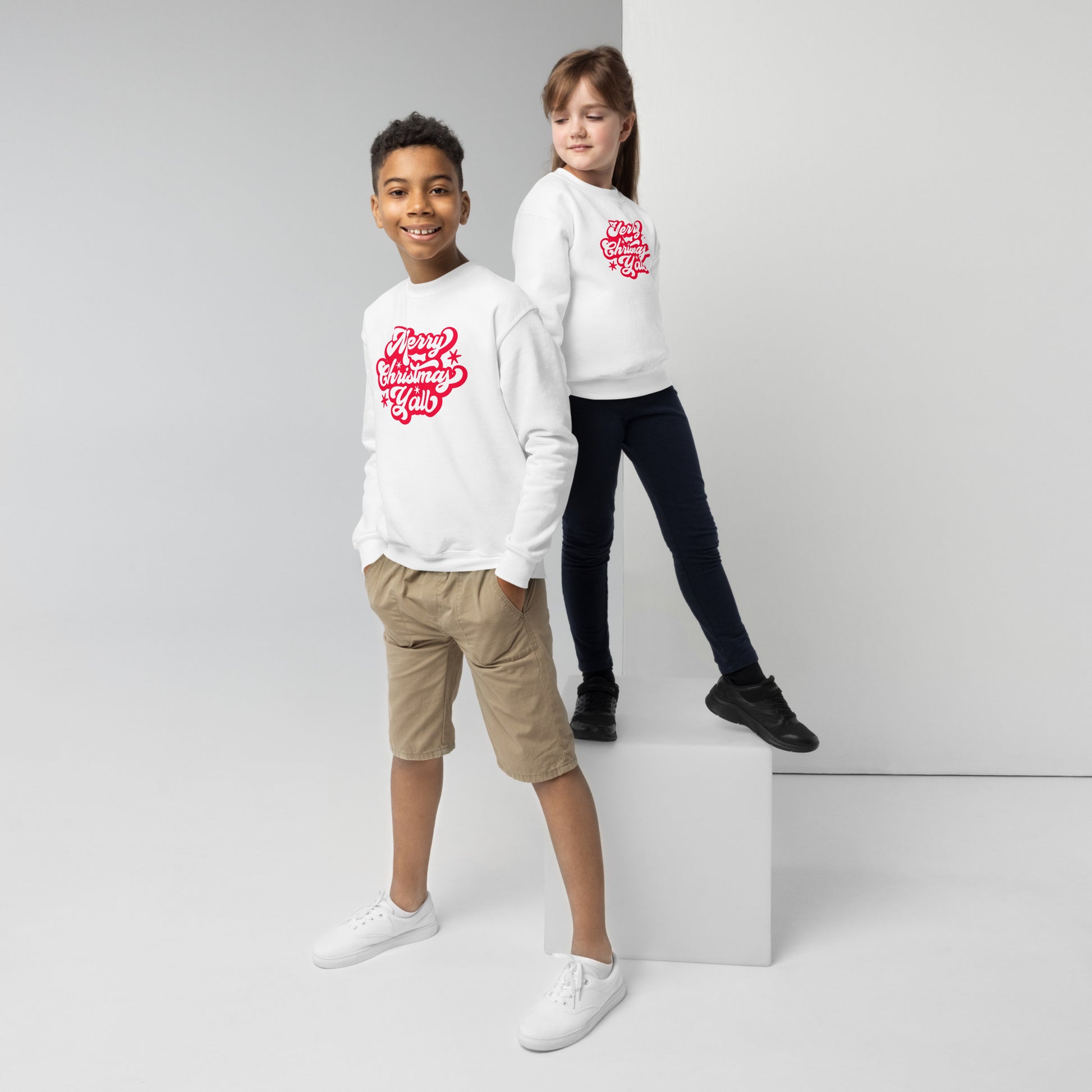 A cheerful red “Merry Christmas Y’all” graphic pops on this classic kids sweatshirt, combining festive vibes with comfort. Ideal for matching family outfits and seasonal events, this Gildan youth pullover is a must-have for your child's Christmas wardrobe.