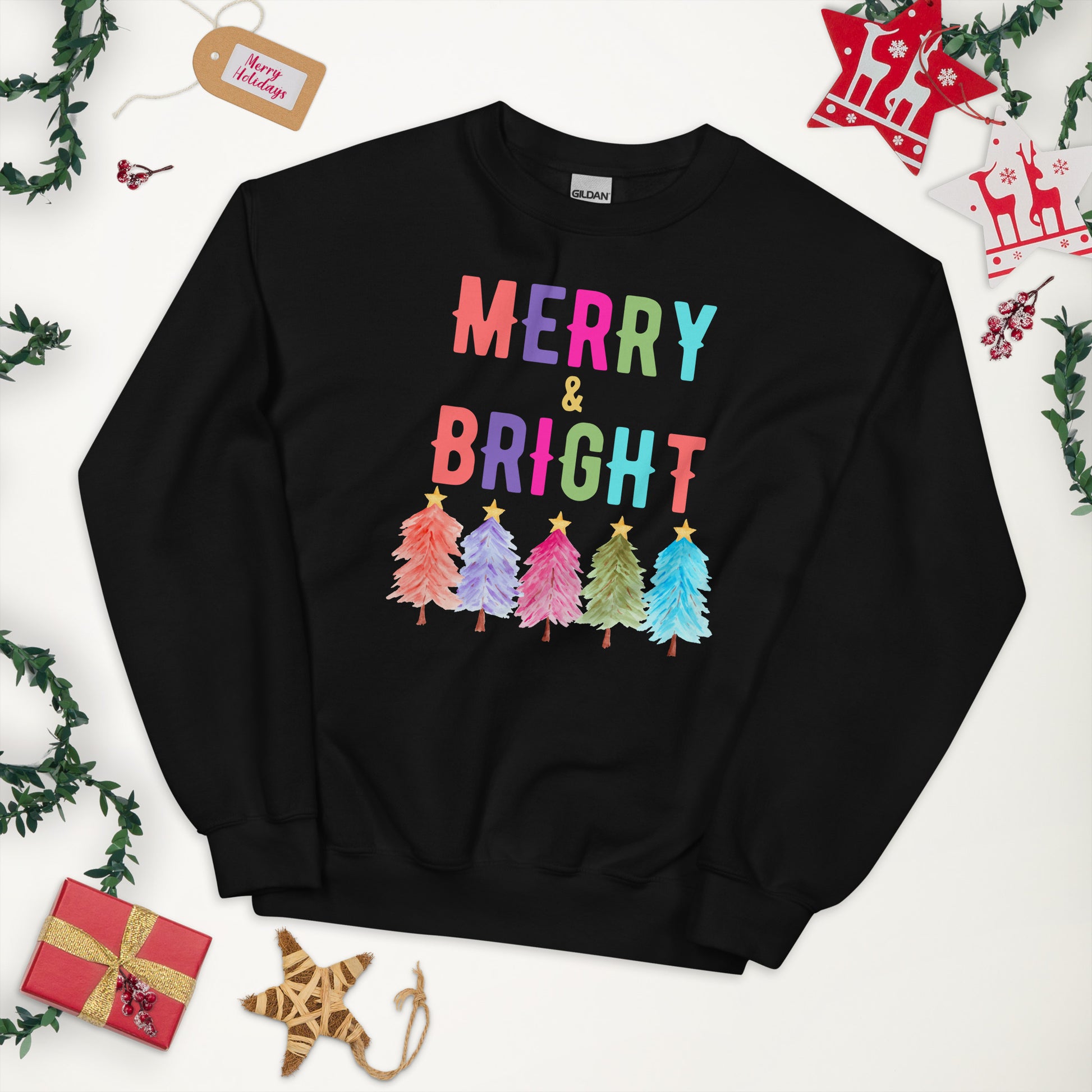 Stay festive and comfortable with our Merry and Bright sweatshirt designed on the premium Gildan 18000. Featuring a playful holiday tree design and bold lettering, this cozy crewneck is available in white, navy, and black in sizes S through 5XL. Perfect for plus size holiday fashion, this unisex Christmas sweatshirt makes a great outfit for holiday parties, family photos, or as a cheerful Christmas gift for friends and loved ones.