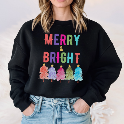 Keep the season cheerful with our Merry and Bright sweatshirt, a cozy Gildan 18000 crewneck featuring colorful Christmas trees and bold holiday lettering. This unisex Christmas sweatshirt comes in white, navy, and black with sizes up to 5XL, making it perfect for plus size shoppers and inclusive gifting. Ideal for Christmas parties, casual wear, or matching family holiday outfits, this festive sweatshirt is a joyful holiday wardrobe staple.