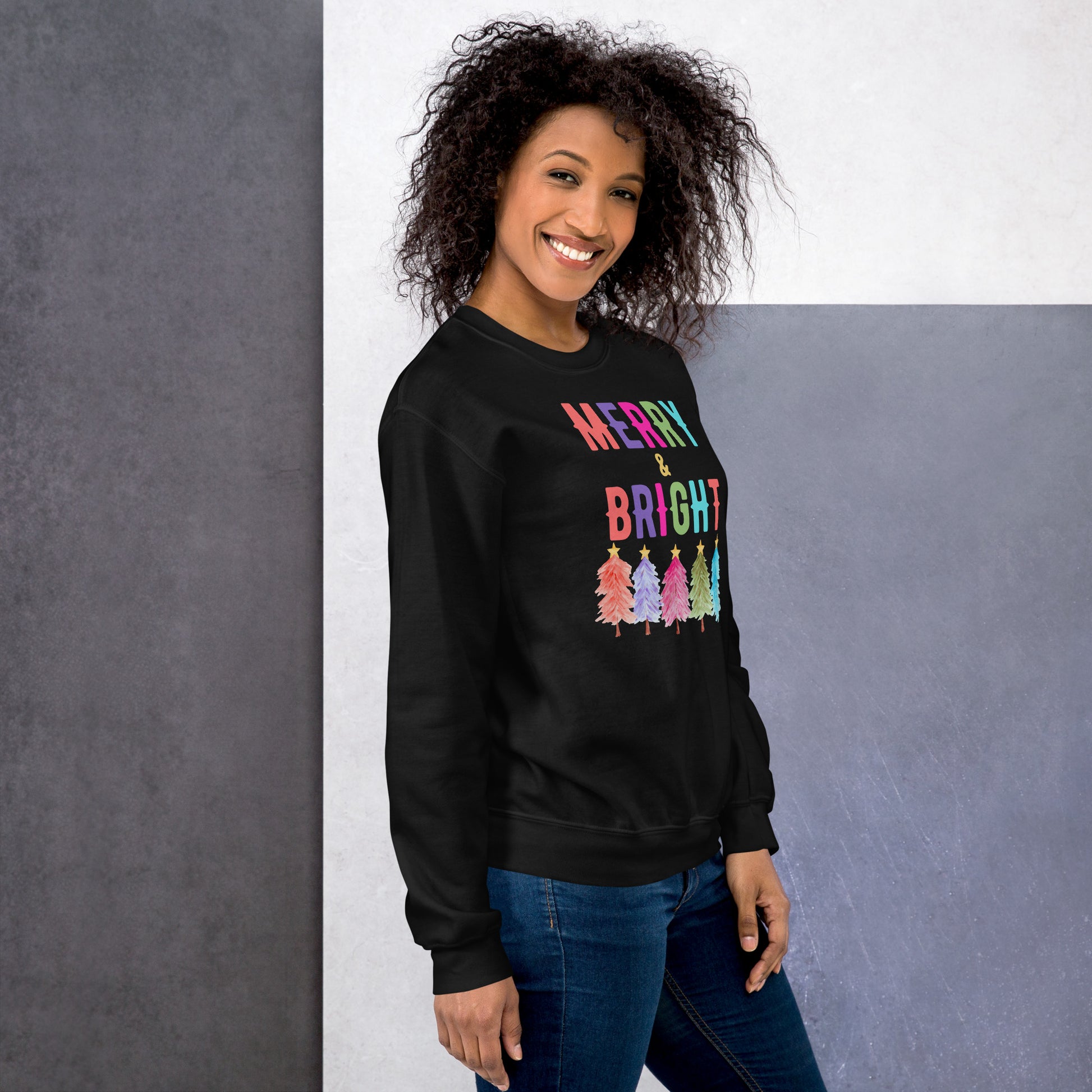 Wrap yourself in festive comfort with this Merry and Bright Christmas sweatshirt printed on the durable Gildan 18000. Designed with rainbow holiday trees and merry lettering, this unisex crewneck offers a cozy fit in white, navy, or black. With sizing from S to 5XL, this sweatshirt is perfect for Christmas celebrations, winter activities, or as a thoughtful holiday gift idea for moms, teachers, friends, and families who love seasonal fashion.