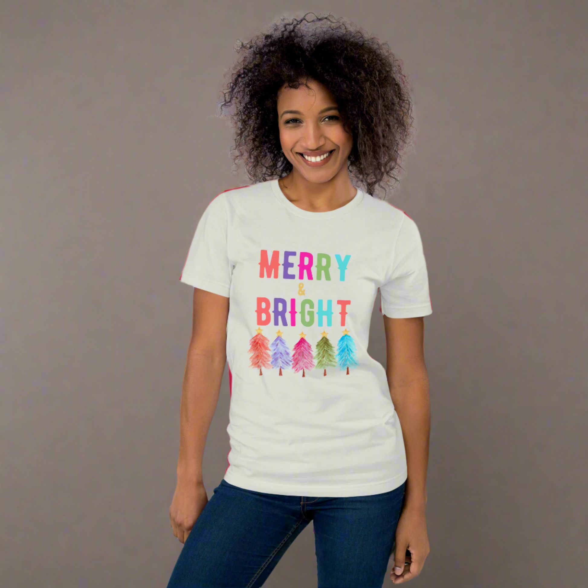 Make your season merry with this Bella Canvas Merry and Bright shirt, featuring vibrant holiday trees in a festive design. This Christmas graphic tee is available in multiple colors and plus sizes, making it ideal for moms, teachers, and anyone who loves fun holiday outfits. Whether worn for Christmas parties, cozy winter days, or family holiday photos, this unisex Christmas shirt adds cheerful style to your seasonal wardrobe.