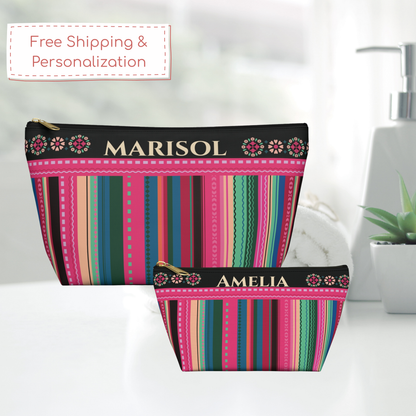 Personalized colorful travel pouch with a serape inspired pattern, custom name, floral details and gold zipper, ideal for organizing makeup, toiletries, skincare and accessories in a carry on, weekender bag or suitcase for vacations and girls trips to Mexico