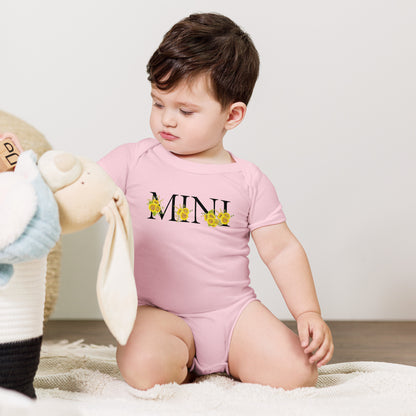 Mini Sunflower Baby Bodysuit printed on Bella Canvas 100B in White or Pink with adorable “MINI” sunflower calligraphy. Soft, breathable fabric is gentle on delicate skin, while envelope neckline and snap closure make diaper changes simple. Part of a matching family outfit collection with MAMA sweatshirt and tee, this baby bodysuit is perfect for gifts, newborn wardrobe, family photos, or special celebrations.