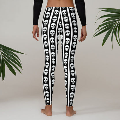 Image: Turn heads in these graphic leggings showcasing monochrome vertical stripes and skull motifs running along the legs. The slim fit and soft material make them perfect for yoga, lounging, or layering with a band tee. These leggings cater to fans of rocker chic, alternative aesthetics, and Halloween lovers alike, available in XS to XL for a versatile and bold wardrobe addition, by jaecrece.