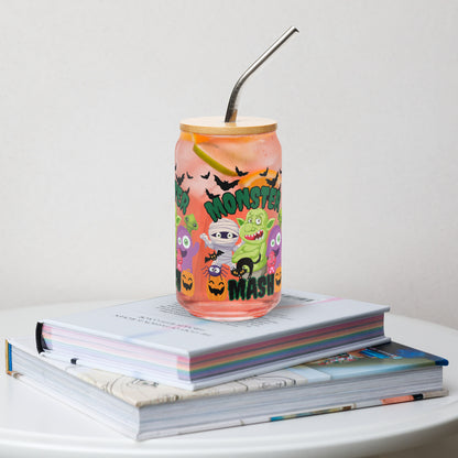 Monster Mash 16 oz reusable glass can with bamboo lid and straw, decorated with colorful monsters, bats, and pumpkins. Ideal Halloween iced coffee cup, cocktail glass, or soda tumbler for festive fall gatherings and parties. Fun spooky season drinkware for everyday sipping or entertaining. Makes a unique eco-friendly gift for friends, family, or teachers. Trendy reusable Halloween glass cup and durable fall beverage can.
