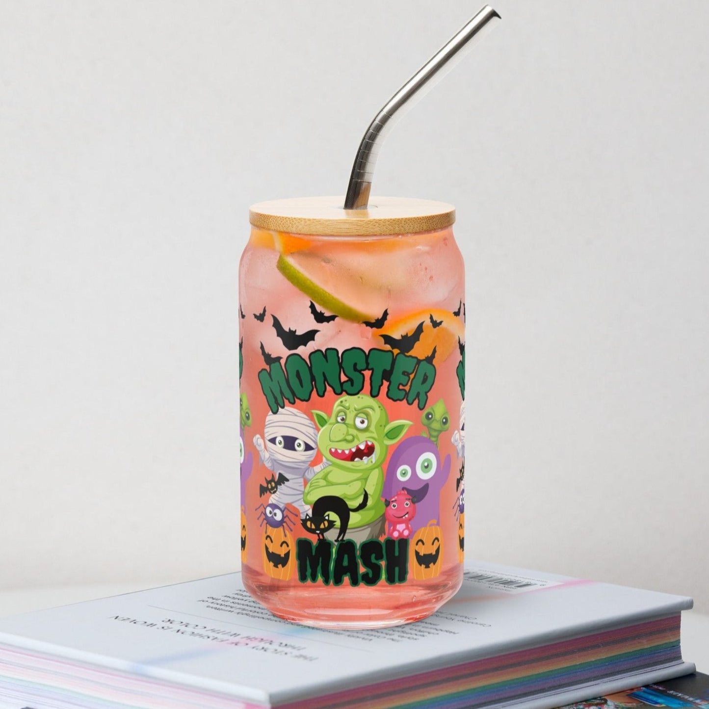 Halloween Monster Mash 16 oz glass can with bamboo lid and reusable straw, featuring playful monsters, pumpkins, and bats for a spooky fun vibe. Ideal for iced coffee lovers, soda drinkers, and cocktail fans who want festive fall drinkware. Durable and eco-friendly, this tumbler is perfect for Halloween parties, seasonal gifts, or everyday use. Cute reusable glass cup for spooky season and fall entertaining.