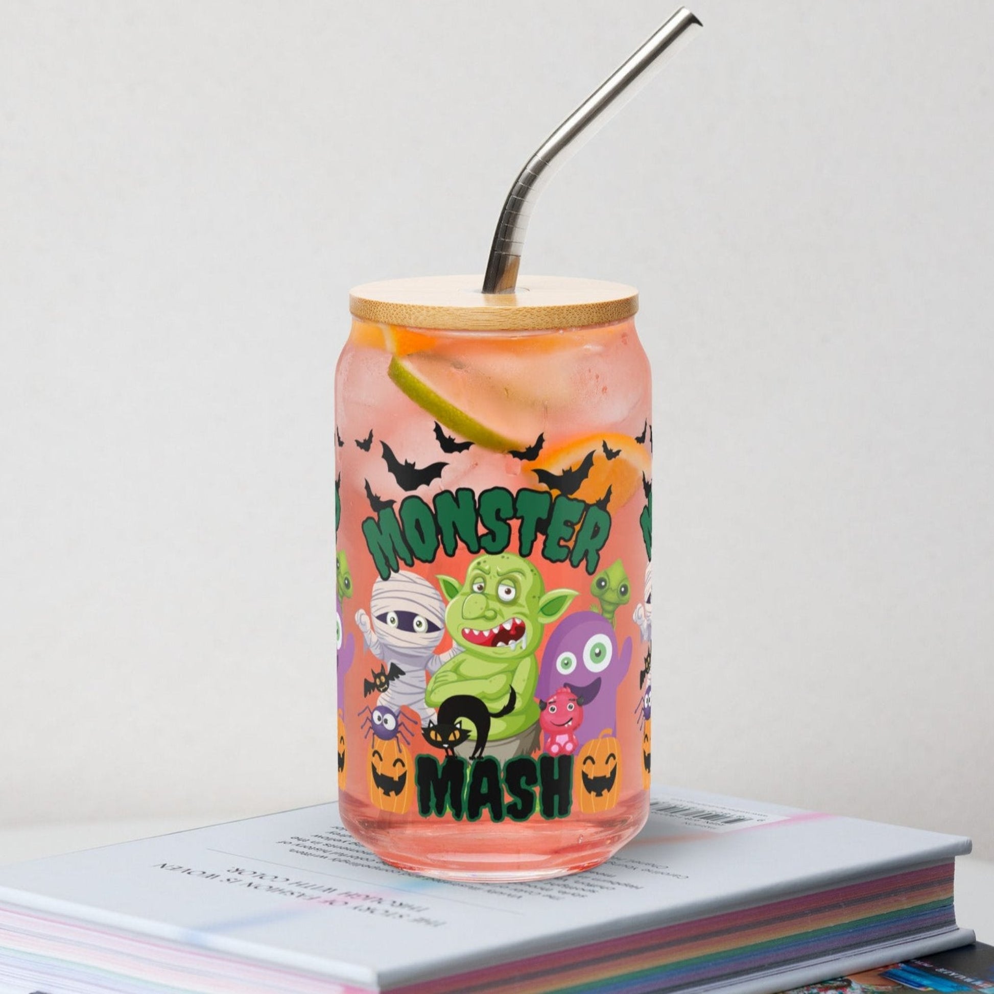Halloween Monster Mash 16 oz glass can with bamboo lid and reusable straw, featuring playful monsters, pumpkins, and bats for a spooky fun vibe. Ideal for iced coffee lovers, soda drinkers, and cocktail fans who want festive fall drinkware. Durable and eco-friendly, this tumbler is perfect for Halloween parties, seasonal gifts, or everyday use. Cute reusable glass cup for spooky season and fall entertaining.