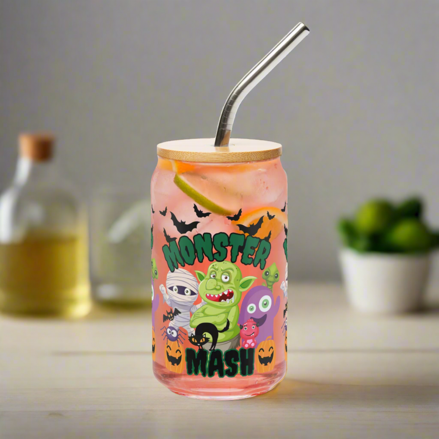 Monster Mash 16 oz sipper glass can with bamboo lid and stainless steel straw, decorated with cute Halloween monsters, pumpkins, bats, and spooky details. Perfect iced coffee glass, cocktail cup, or sparkling water tumbler for fall entertaining. Eco-friendly reusable drinkware and fun seasonal gift idea for friends, teachers, or family. Trendy Halloween party cup, spooky season glass, festive fall beverage can.