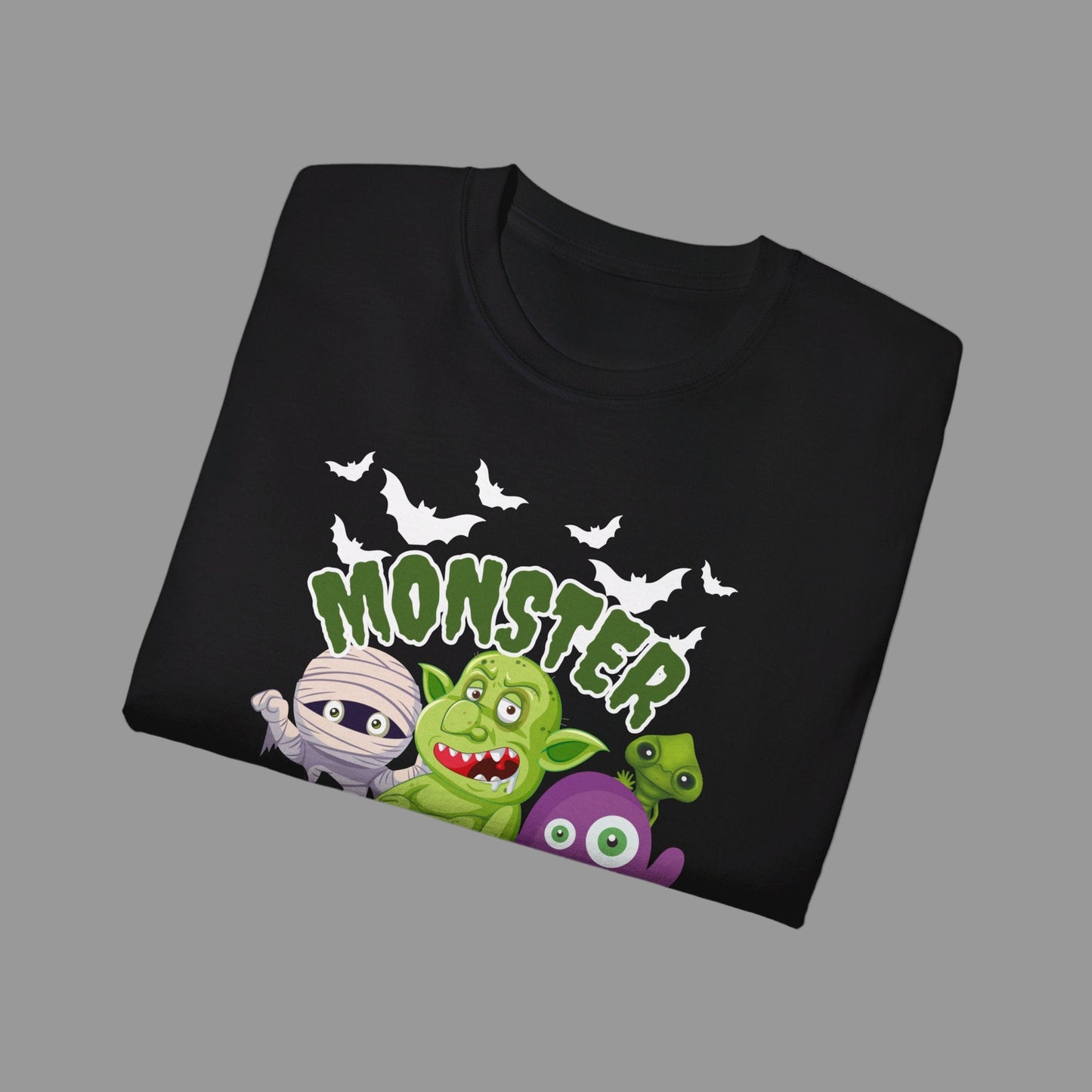 Halloween party graphic shirt in black with Monster Mash design, featuring cartoon characters like a spooky mummy, pumpkins, bats, troll, and spider. Printed on soft 100% cotton Gildan 2000, this adult unisex tee is available in S–5XL and perfect for haunted houses, trick-or-treating, or everyday fall outfits. A playful spooky season t-shirt that makes a festive gift idea for Halloween lovers, friends, or family celebrating the holiday.