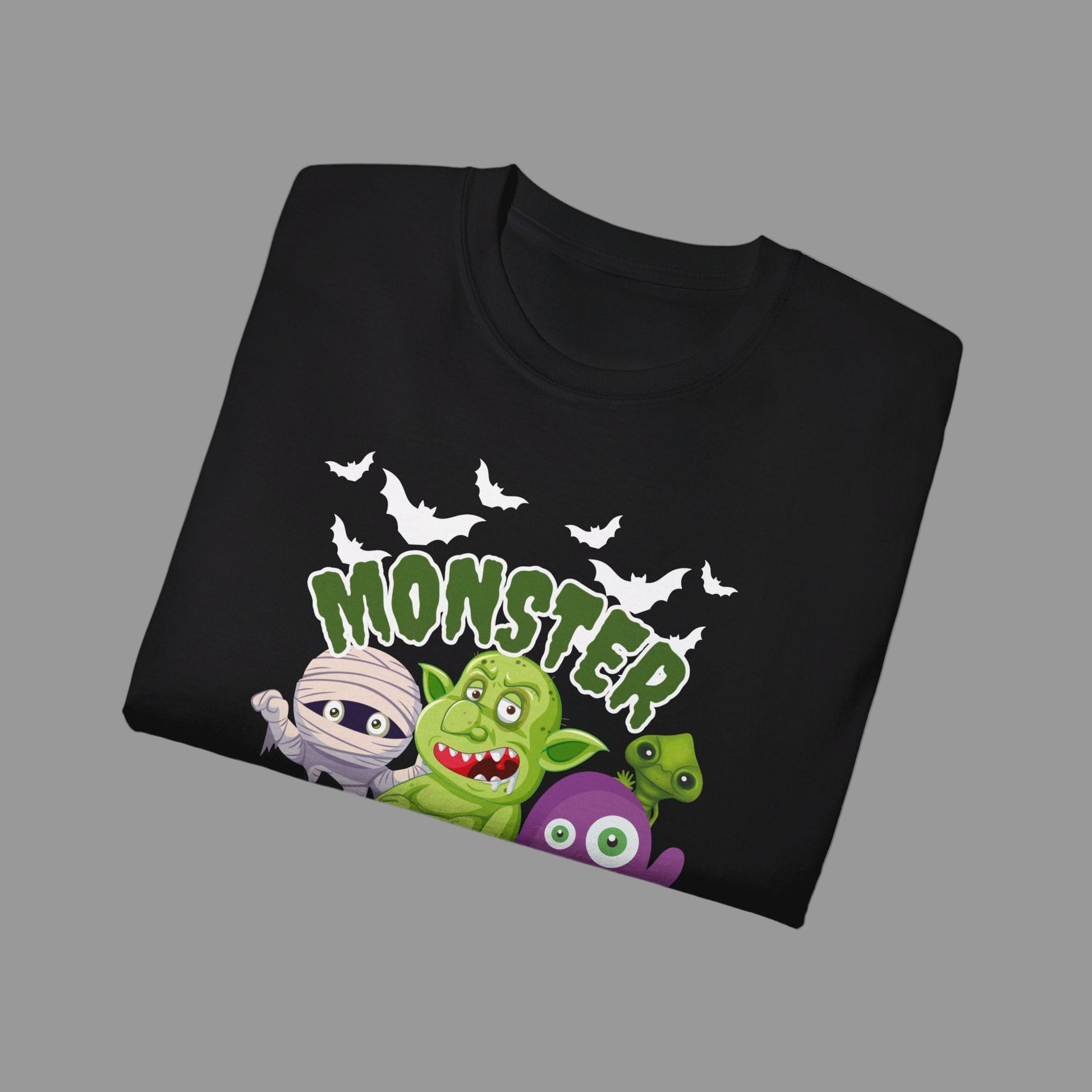 Halloween party graphic shirt in black with Monster Mash design, featuring cartoon characters like a spooky mummy, pumpkins, bats, troll, and spider. Printed on soft 100% cotton Gildan 2000, this adult unisex tee is available in S–5XL and perfect for haunted houses, trick-or-treating, or everyday fall outfits. A playful spooky season t-shirt that makes a festive gift idea for Halloween lovers, friends, or family celebrating the holiday.