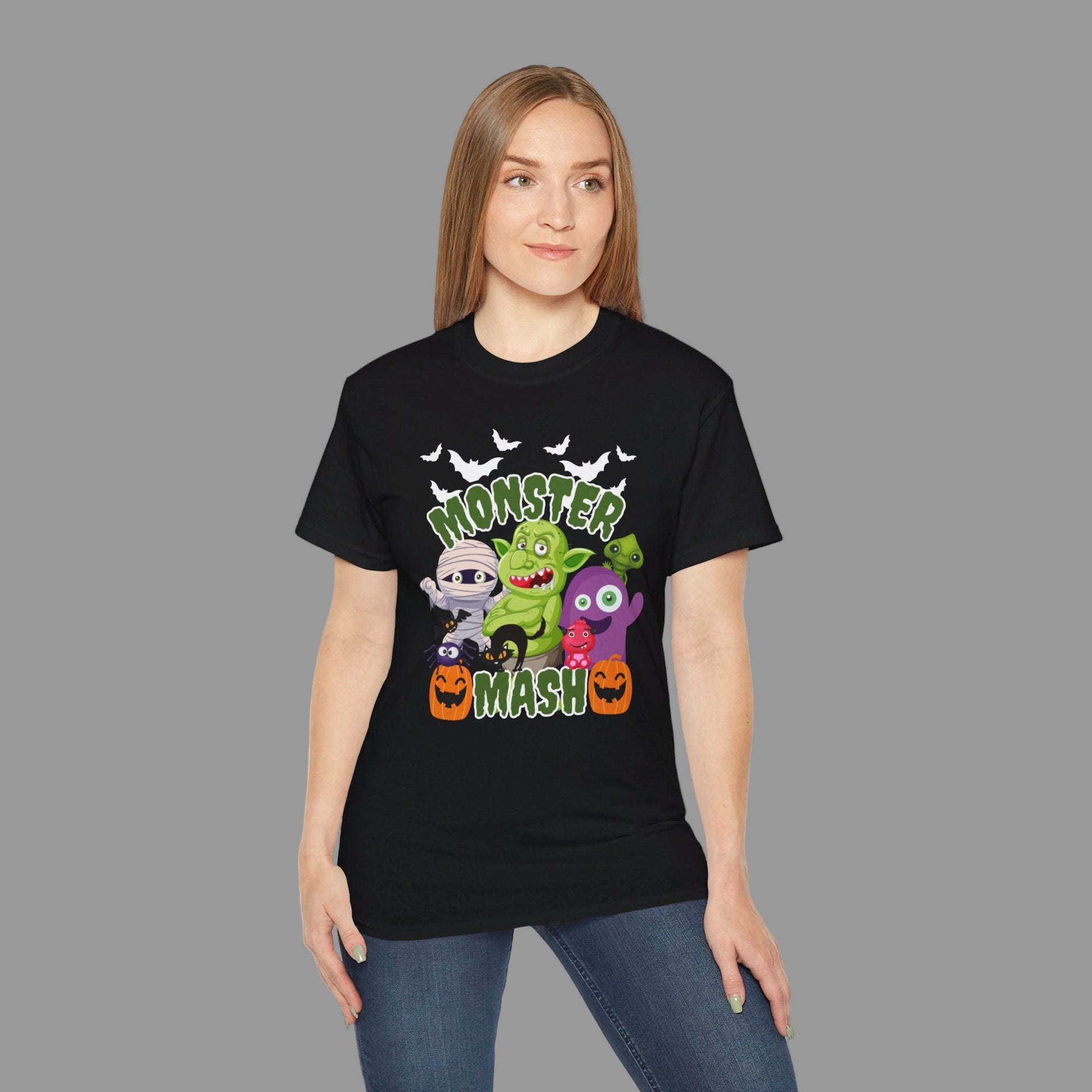 Front view of a Halloween Monster Mash graphic shirt, showing bold cartoon artwork with pumpkins, bats, troll, spider, and mummy. Printed on the Gildan 2000 in soft cotton, this unisex Halloween t-shirt is available in black or charcoal, sizes S–5XL. Perfect for haunted houses, trick-or-treating, spooky season parties, or fall casual wear, this Halloween tee makes a thoughtful seasonal gift for men and women who love festive style.