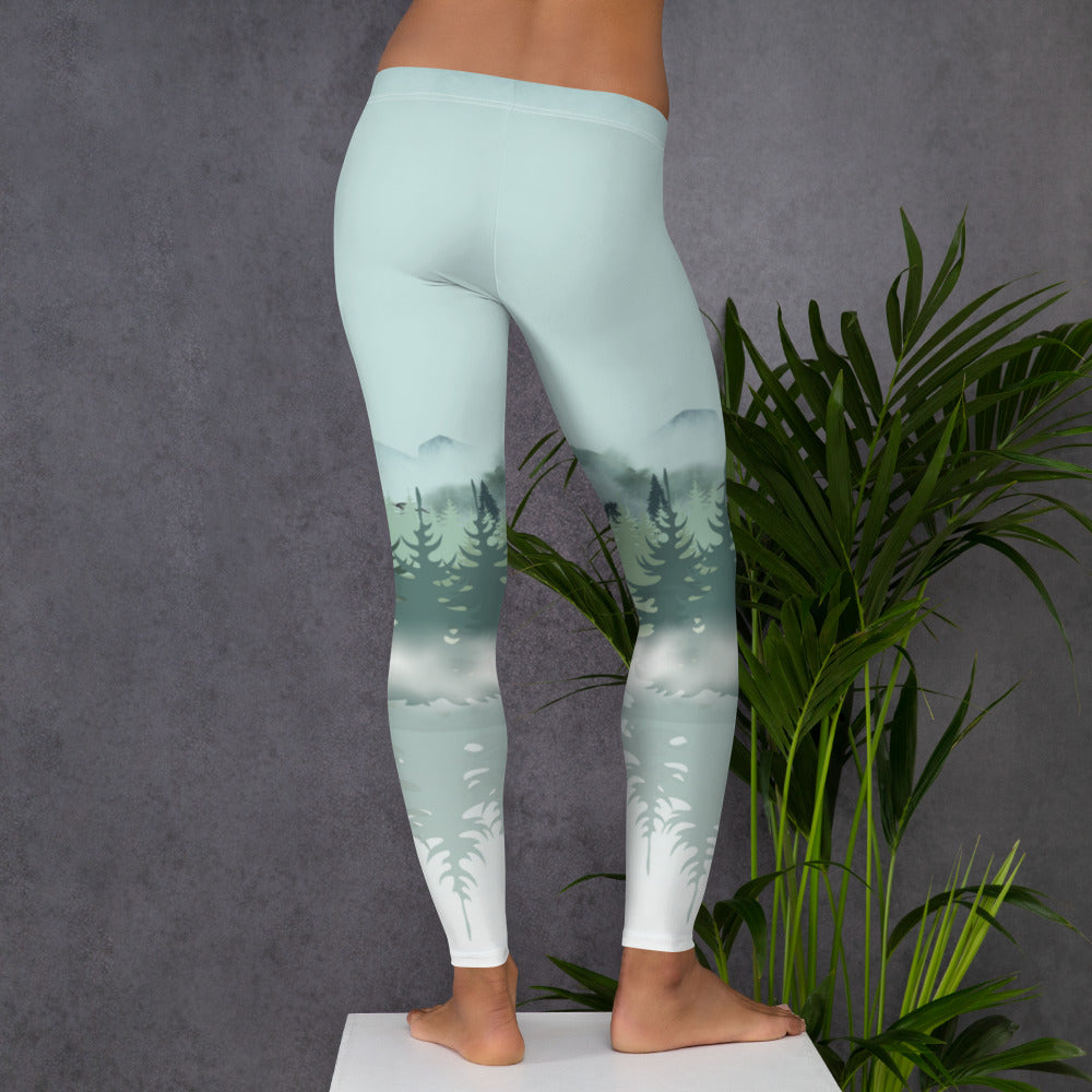 Winter Forest leggings designed with a misty alpine view of mountains and snowy pine trees that create a calming mountaincore and nature inspired look. Perfect for winter exercise, cozy holiday outfits, and outdoor themed family photos. Womens sizes XS to XL coordinate with girls sizes 2T to 20 for adorable mommy and me combinations that celebrate forestcore and winter wander vibes.