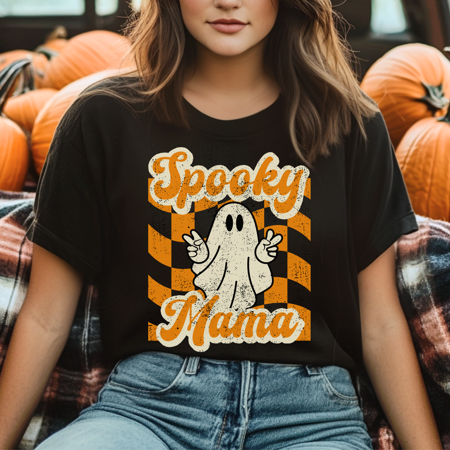 Black Spooky Mama Halloween shirt printed on a soft Gildan 64000 Softstyle tee featuring a fun seasonal design for moms who love spooky season style. Lightweight comfortable graphic tshirt perfect for pumpkin patch days, trick or treat nights, school parties, haunted house outings, coffee runs, and cozy fall weekends. Cute Halloween mom shirt pairs easily with jeans, leggings, flannel, and boots. Matching Spooky Mini kids shirt available for adorable family photos. Free U.S. Shipping.