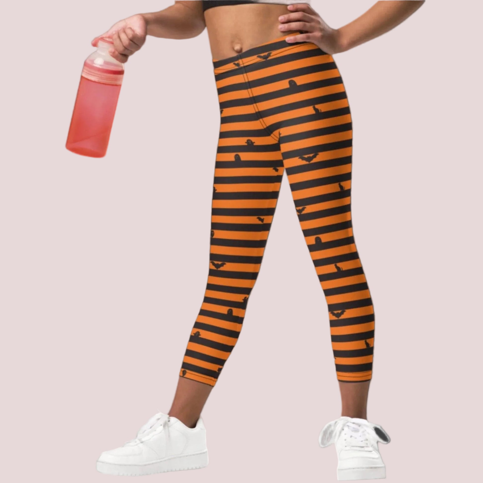 Cute Halloween leggings for toddlers with a festive black and orange striped print perfect for trick or treating and fall outfits
