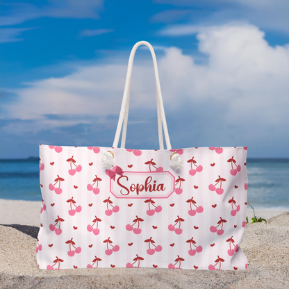 Oversized personalized cherry weekender bag designed with a cute coquette aesthetic and custom name personalization. This versatile travel tote works as an overnight bag, carry on, beach bag, dance competition tote, or hospital bag while offering plenty of room for essentials. A thoughtful personalized gift for bridesmaids, graduates, college students, and anyone who loves feminine travel accessories with timeless charm.