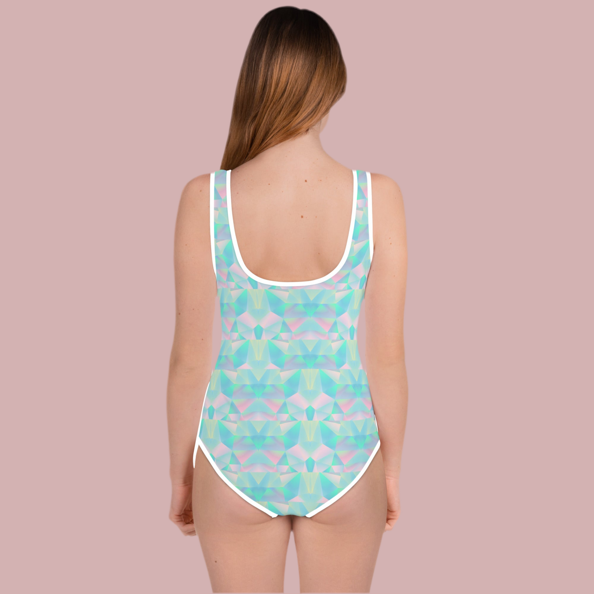 A playful geometric prism print in dreamy shades of teal blue, pink, and purple covers this girls swimsuit, creating a fun pastel aesthetic for summer adventures. Available in sizes 2T through 20, this one piece is part of a matching family swim collection that makes group photos extra special. Great for beach vacations, lake weekends, pool parties, family reunions, and gifts for daughters, granddaughters, cousins, and sisters.