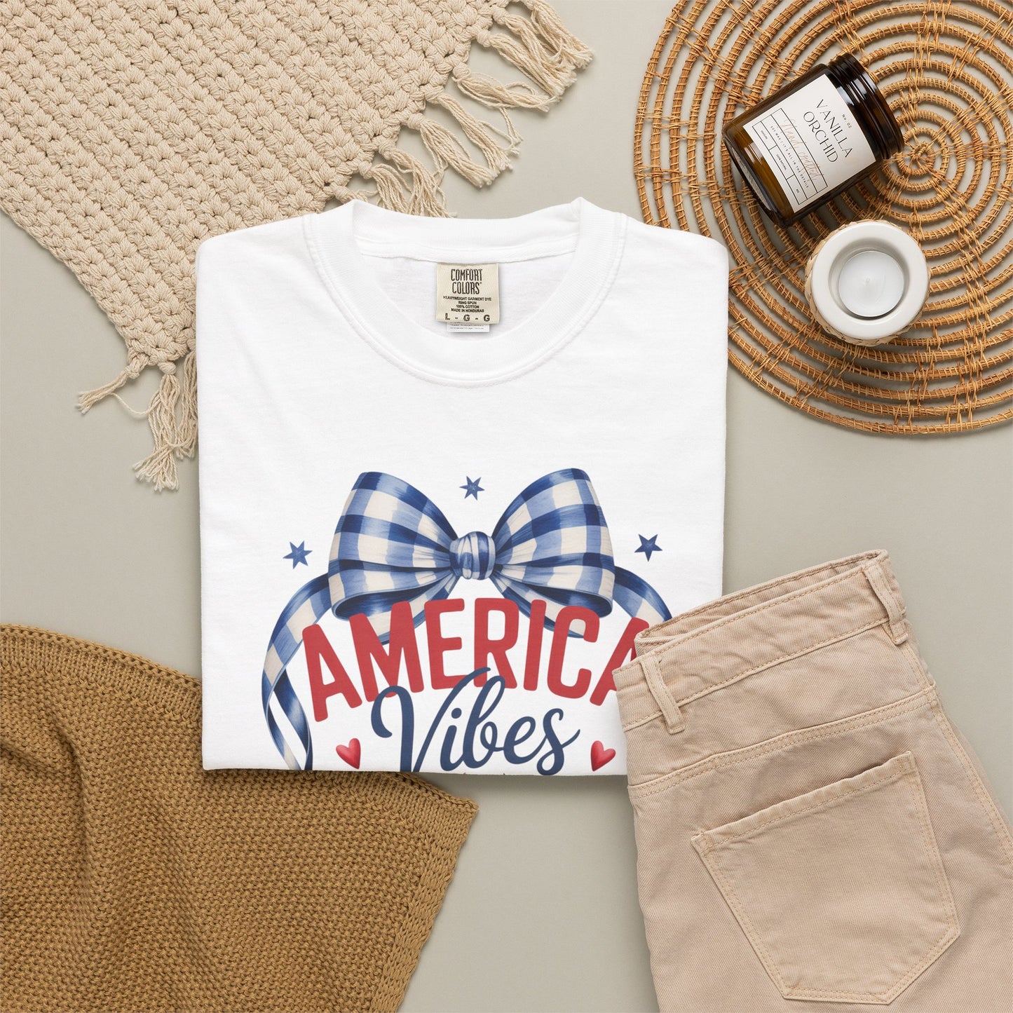 Patriotic strawberry Comfort Colors 1717 t shirt featuring vintage Americana inspired artwork with a strawberry graphic gingham bow patriotic stars and heart accents. Soft garment dyed cotton tee with relaxed unisex fit available in white chambray and blossom colors. Perfect for America 250 celebrations 4th of July family gatherings mommy and me matching outfits Memorial Day vacations patriotic parades and nostalgic summer outfits with red white and blue style