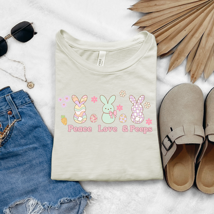Image: Peace Love and Peeps Easter Shirt for Adults and Children. This Mommy and Me Match Easter Tee features Peeps Easter Candy with Easter Eggs and Daisies. A great Easter shirt for your family holiday celebrations, by jaecrece