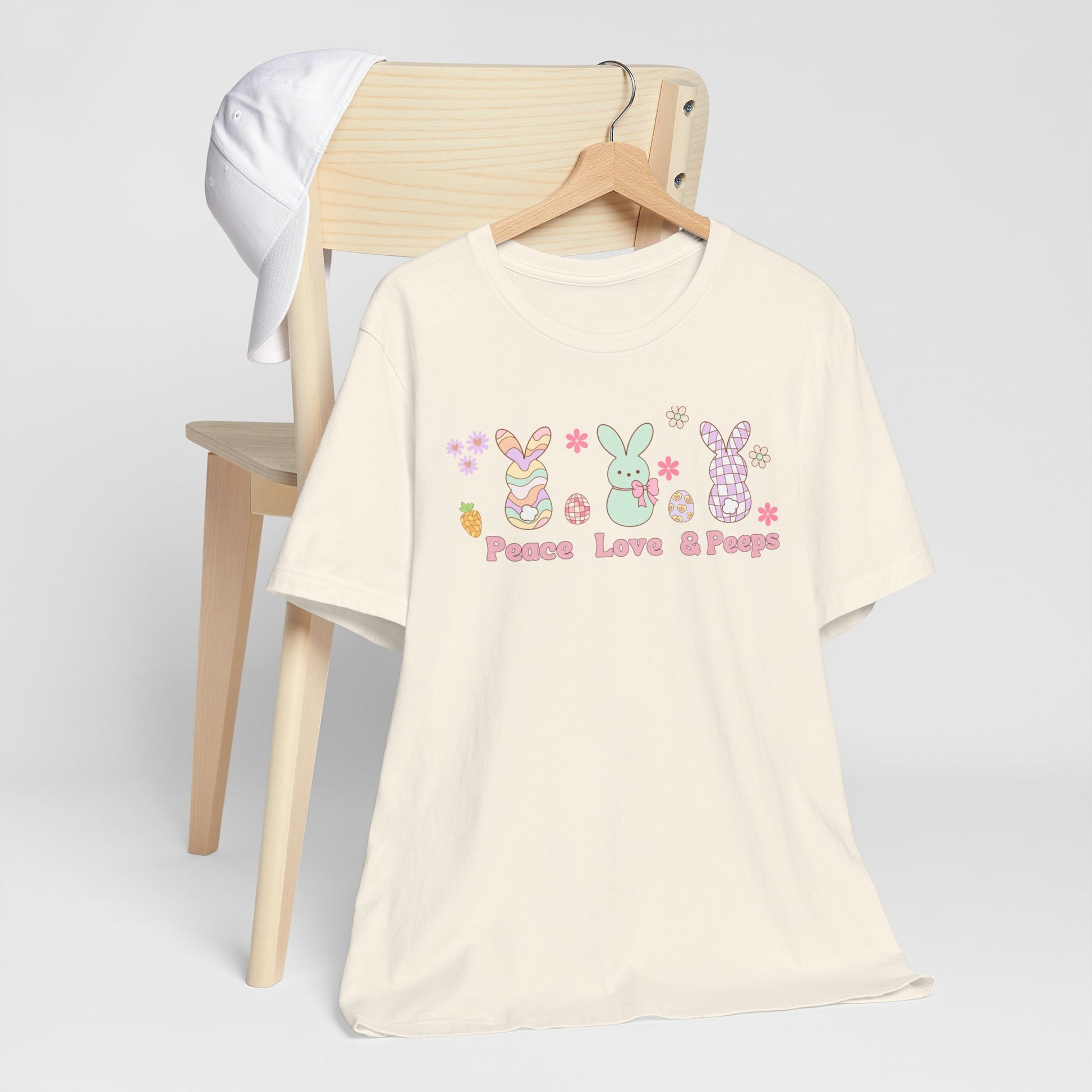 Image: Peace Love and Peeps Easter Shirt for Adults and Children. This Mommy and Me Match Easter Tee features Peeps Easter Candy with Easter Eggs and Daisies. A great Easter shirt for your family holiday celebrations, by jaecrece
