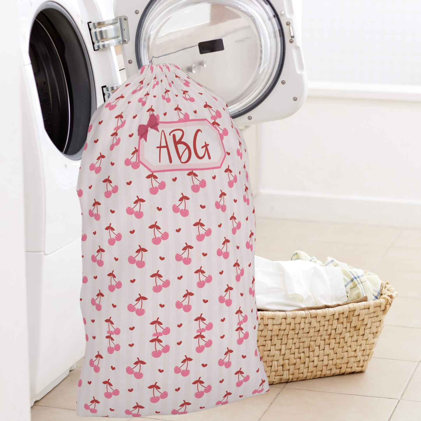 Personalized laundry bag with a sweet coquette cherry design and custom name personalization, offering a stylish solution for organizing clothes at home or on the go. The roomy drawstring construction easily accommodates a full load of laundry, making it perfect for college move in, summer camp, boarding school, sleepovers, and vacations. This charming laundry sack blends everyday function with a soft feminine aesthetic and makes a beautiful personalized gift for all ages.