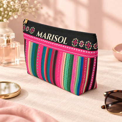 Personalized colorful serape inspired makeup bag with custom name, floral details, vibrant pink, teal, green and blue stripes, black accents, gold zipper, and spacious travel pouch for Latina gifts, quinceañera gifts, makeup, toiletries, and travel