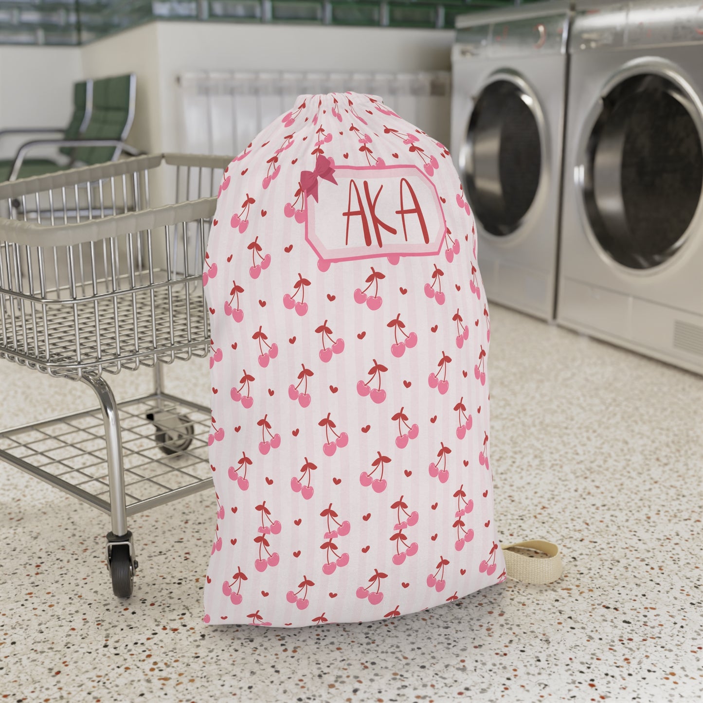 Personalized coquette cherry laundry bag featuring a playful cherry print and custom name personalization. This spacious drawstring laundry sack is designed for college dorms, summer camp, family vacations, sleepovers, and everyday organization. Large enough to hold clothing, towels, and bedding, it helps keep laundry neatly contained while adding a charming feminine touch. The coordinated design pairs beautifully with matching travel accessories and makes a thoughtful personalized gift for students, camper
