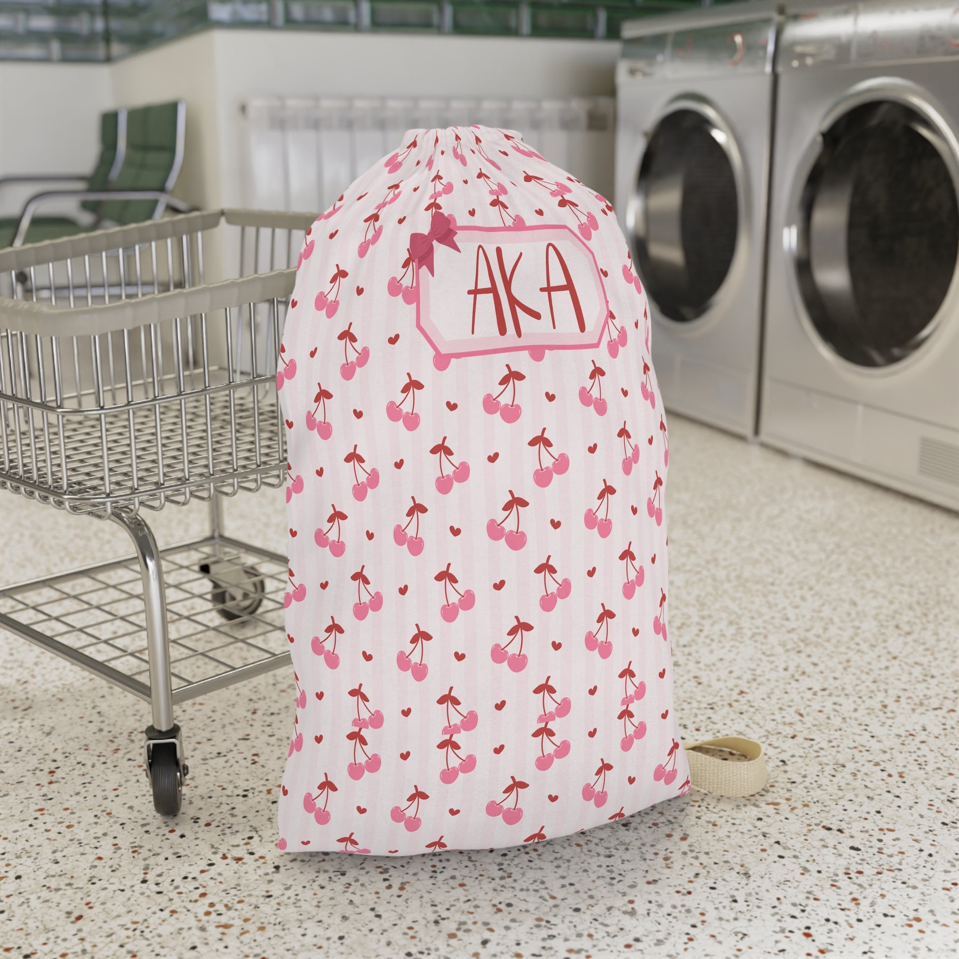 Personalized coquette cherry laundry bag featuring a playful cherry print and custom name personalization. This spacious drawstring laundry sack is designed for college dorms, summer camp, family vacations, sleepovers, and everyday organization. Large enough to hold clothing, towels, and bedding, it helps keep laundry neatly contained while adding a charming feminine touch. The coordinated design pairs beautifully with matching travel accessories and makes a thoughtful personalized gift for students, camper