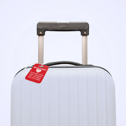 Personalized kids medical alert luggage tag attached to a child’s suitcase for travel. Custom emergency ID bag tag helps keep important medical information visible for family vacations, flights, school trips, camps, and everyday adventures.