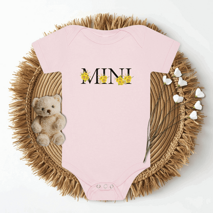 Soft baby bodysuit with MINI sunflower design in coordinating White or Pink Bella Canvas 100B fabric. Designed for comfort and easy dressing with envelope neckline and three-snap leg closure, this Mini Sunflower Baby Bodysuit pairs perfectly with MAMA sweatshirt and tee for a matching family outfit. Ideal for newborns, toddlers, or gifting, it’s a stylish and practical choice for everyday wear or special moments.