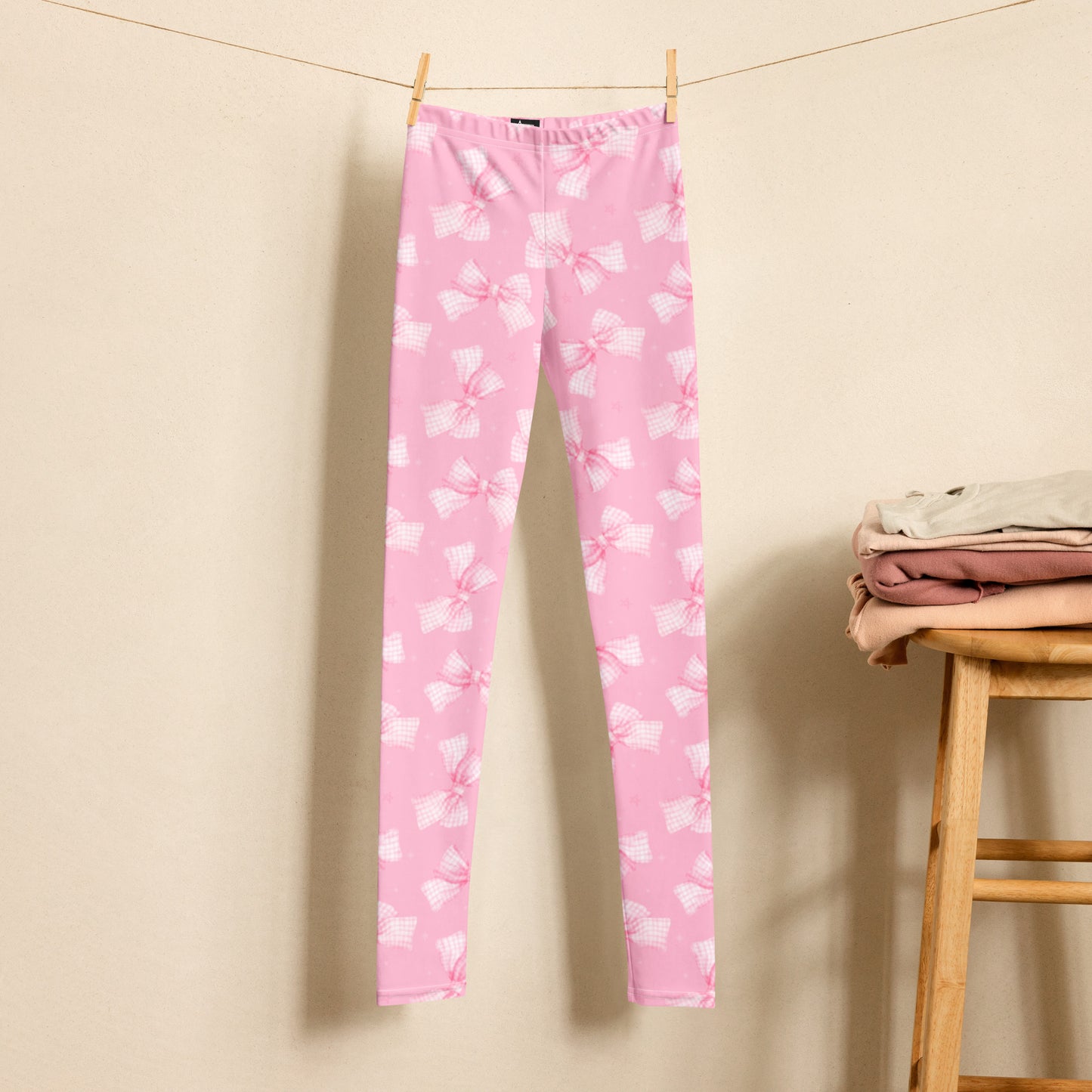 Image: These pink bow coquette leggings for youth sizes 8 to 20 feature a playful gingham ribbon print perfect for girls who love cute and stylish outfits. The soft stretch fabric makes them great for dance class, school days, or weekend fun. Their vintage-inspired design brings a sweet flair to any wardrobe and makes a wonderful gift for birthdays or special occasions, by jaecrece.