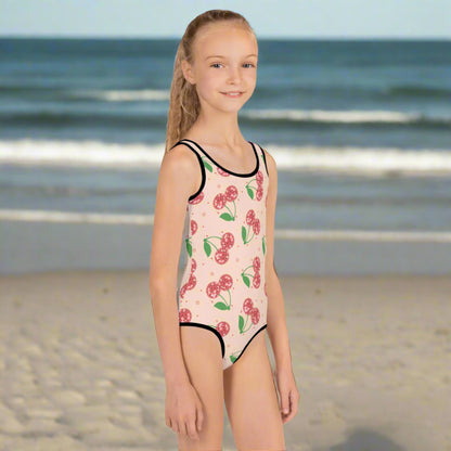 Toddler girl pink swimsuit with red disco cherries, available in sizes 2T–7. Custom matching swimsuit also available in adult sizes for a fun mommy and me look. Features UPF 38–40, durable stretch fabric, and comfy double-layered front. Perfect for summer birthdays, beach vacations, spring break, or poolside twinning with mom. Great gift idea for toddlers, daughters, and nieces.


