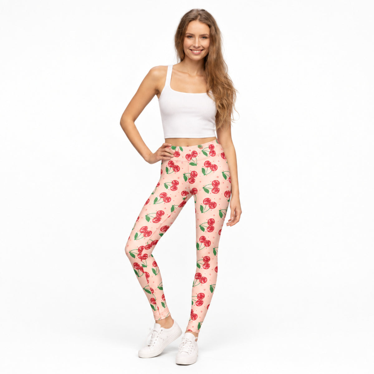 Pink cherry print womens leggings featuring a bright pink background with sparkling red cherries and playful decorative details. These full length leggings have a comfortable mid rise fit and colorful retro style that works beautifully for Cherry Girl fashion, cute casual outfits, nostalgic looks and fun everyday wear.