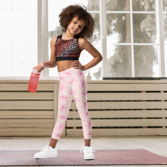 Pink bow coquette girls leggings featuring a feminine all over bow print in a soft pink color palette. These cute leggings are available in sizes 2T through 20 for toddlers, little girls, tweens and teens. Pair them with the matching women’s leggings for an adorable Mommy and Me outfit. Great for school, dance, yoga, playtime and everyday wear.