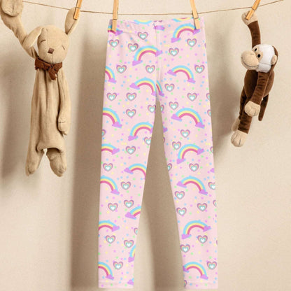 Pink Fairy Tale Toddler Girl Leggings. These pants feature a light pink background with a pattern of stars, hearts and rainbows, by jaecrece