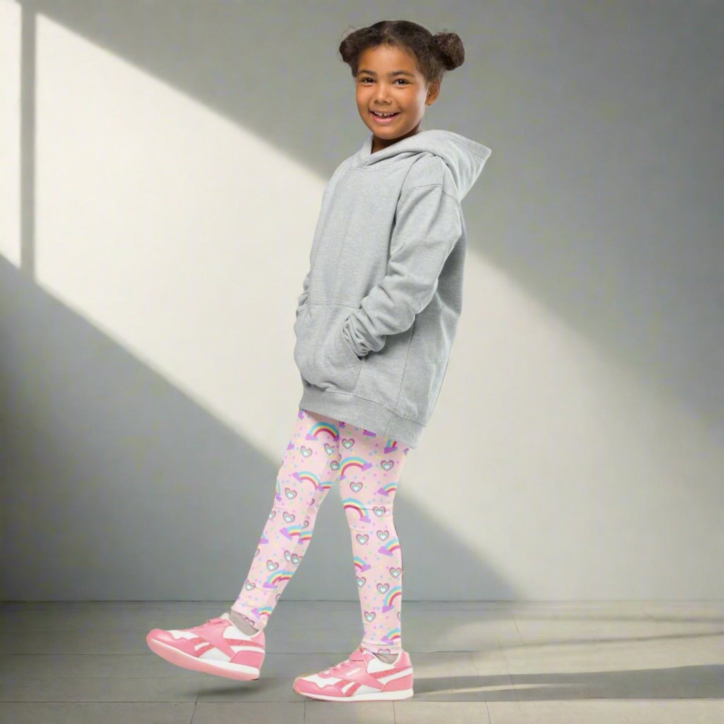 Pink Fairy Tale Girl Leggings. These pants feature a light pink background with a pattern of stars, hearts and rainbows, by jaecrece